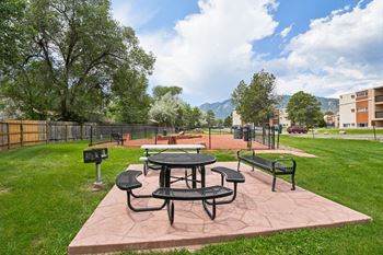 A picnic table and chairs are set up on a patio.